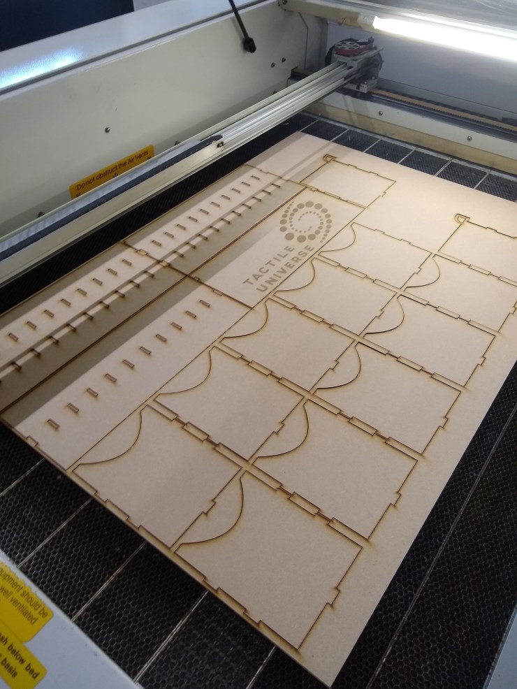 The box pieces after the laser cutter is done cutting them out