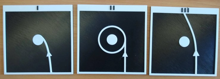 Tree tactile models showing the path of an object moving past a massive planet at tree different speeds. At a slow speed the object hits the planet, at a medium speed the small object falls into an orbit around the planet, and at a fast speed its path is bent as it goes by the planet.