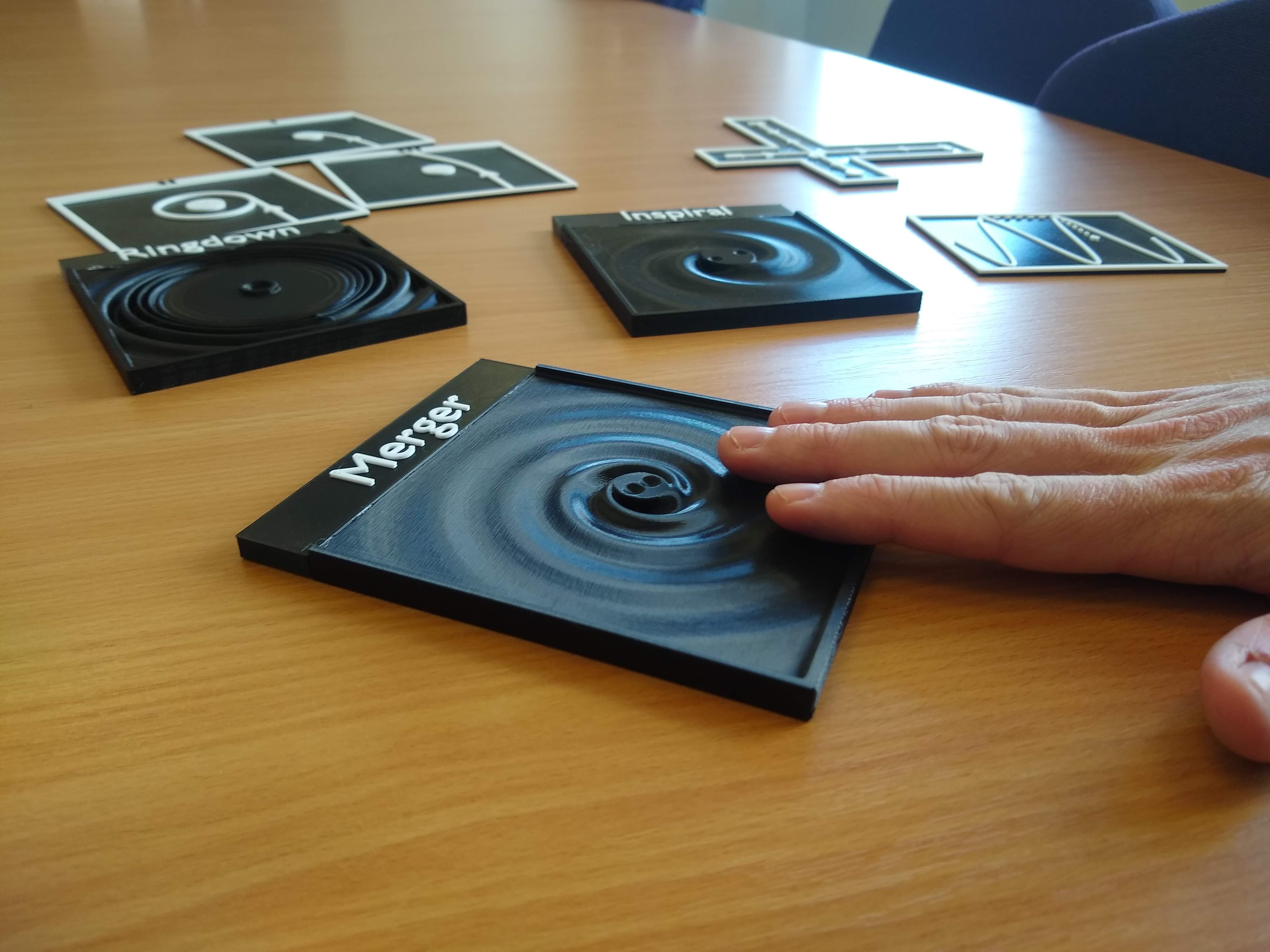 The Tactile Universe gravitational wave models arranged on a table.
